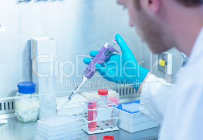 Science student using pipette in the lab