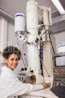 Biochemistry student using large microscope and computer