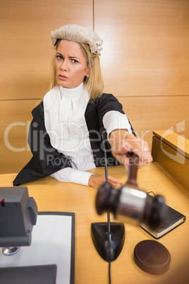 Stern judge pointing her hammer