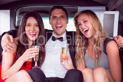 Pretty girls with ladies man in the limousine