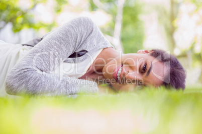 Pretty brunette lying on the grass