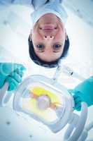 Low angle of female dentist adjusting light