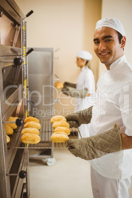 Handsome baker smiling at camera