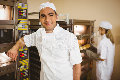 Handsome baker smiling at camera