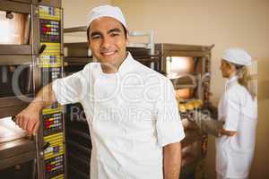 Handsome baker smiling at camera