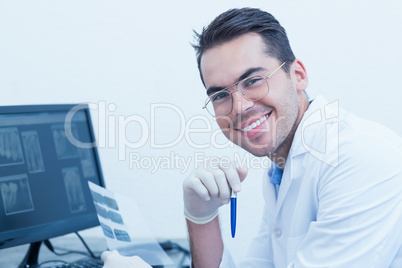 Male dentist with x-ray on computer