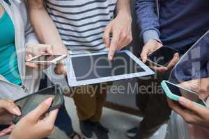 Students using tablet pc and their smartphones