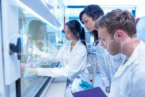 Science students using pipette in the lab