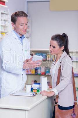 Smiling pharmacist explaining the drug to patient