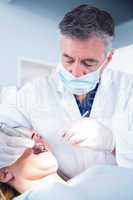 Dentist examining a patients with angled mirror