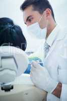 Male dentist examining womans teeth