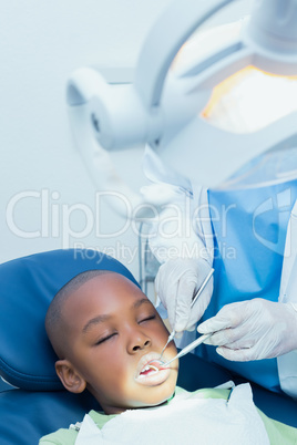 Boy having his teeth examined by dentist