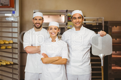 Team of bakers smiling at camera