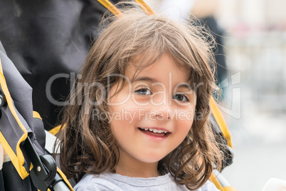 Smiling baby girl on the stroller