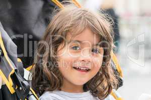 Smiling baby girl on the stroller