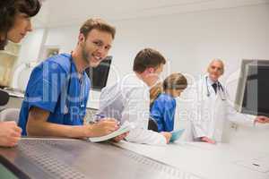 Medical student smiling at the camera during class