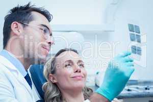 Dentist showing woman her mouth x-ray