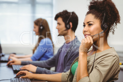 Happy student smiling in computer class