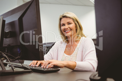 Mature student using laptop looking at camera