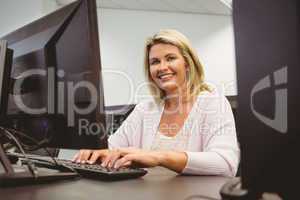 Mature student using laptop looking at camera