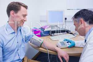 Doctor measuring his patients blood pressure