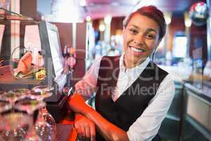 Pretty barmaid smiling at camera