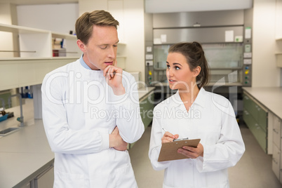 Team of pharmacists looking at clipboard