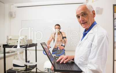 Doctor conducting fitness test smiling at camera