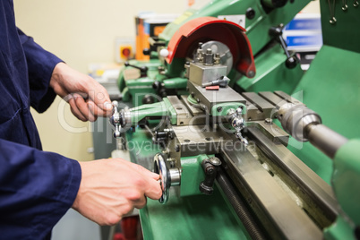 Engineering student using heavy machinery