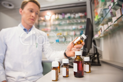 Pharmacist holding jar of medicine