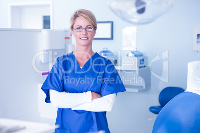 Portrait of a dentist smiling at camera with arms crossed Portrait of a dentist smiling at camera with arms crossed