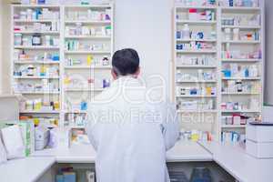 Rear view of a pharmacist working in lab coats