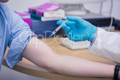 Close up of a doctor about to give an injection