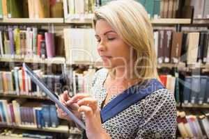 Mature student using tablet in library
