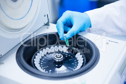 Close up of a chemist using a centrifuge