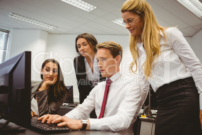 Casual boss showing something to his business team