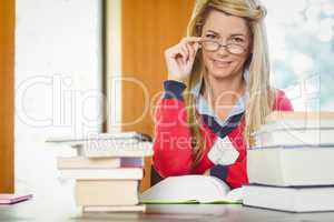 Smiling mature student reading book