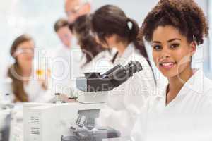 Science student looking through microscope in the lab