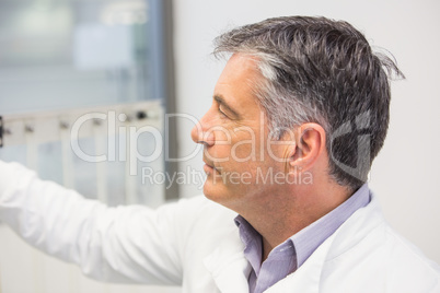 Pharmacist using machinery to make medicine