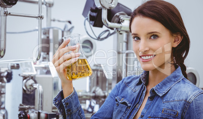 Smiling woman holding a beaker of beer