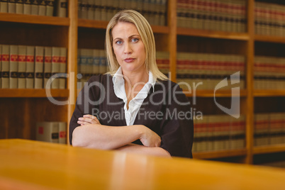 Serious lawyer looking at camera with arms crossed