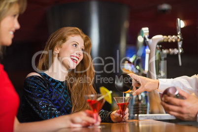 Pretty girls being served cocktails