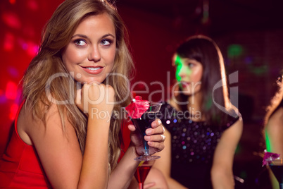 Pretty blonde drinking a cocktail