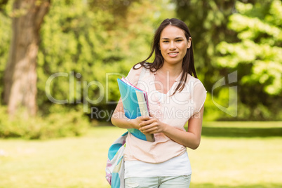 Portrait of an university student holding book