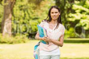 Portrait of an university student holding book