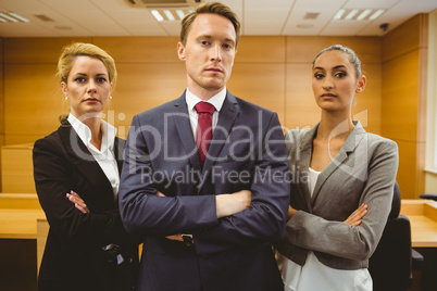 Three serious lawyers standing with arms crossed