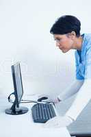Female dentist looking at computer monitor