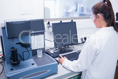 Young scientist typing on his computer