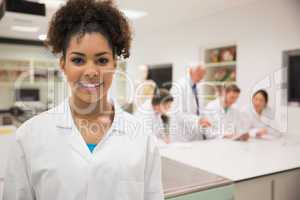 Pretty science student smiling at camera