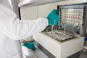 Young scientist using a pipette in chamber